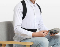 Man sitting on a chair holding a magazine with a white background