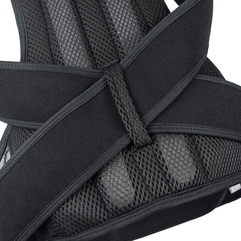 Close-up of a black and gray back brace with mesh design on a white background