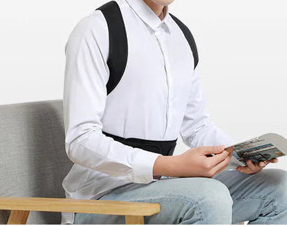 Man sitting on a chair holding a magazine with a white background