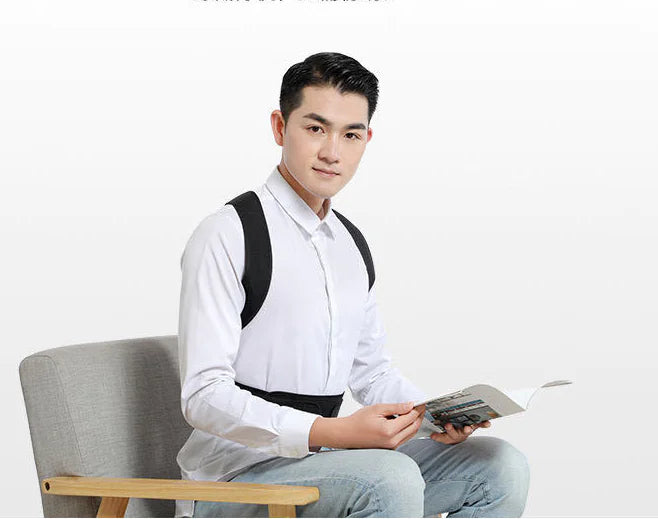 Man sitting on a chair holding a magazine with a white background